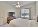 Bright bedroom featuring neutral walls, carpet, ceiling fan and window with a backyard view at 603 S Sylvan Dr, Brandon, FL 33510