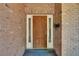 Classic wood front door with sidelights and brick surround exudes traditional charm at 603 S Sylvan Dr, Brandon, FL 33510