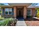 Inviting front entrance with brick facade, tiled entryway, and decorative landscaping at 603 S Sylvan Dr, Brandon, FL 33510