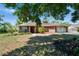 Brick home featuring a two-car garage and manicured landscaping in a verdant neighborhood at 603 S Sylvan Dr, Brandon, FL 33510