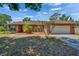Charming brick home with a well-manicured front yard and an attached two-car garage at 603 S Sylvan Dr, Brandon, FL 33510