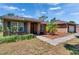 Brick home features an attached garage, and well-maintained landscaping at 603 S Sylvan Dr, Brandon, FL 33510