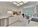 Well-lit kitchen with white appliances and tile features a window-framed breakfast nook with a table and chairs at 603 S Sylvan Dr, Brandon, FL 33510