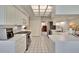 Bright white kitchen with stainless steel appliances and adjacent breakfast nook and study at 603 S Sylvan Dr, Brandon, FL 33510