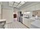 Bright white kitchen shows stainless appliances and is open to the breakfast nook and study at 603 S Sylvan Dr, Brandon, FL 33510