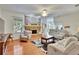 Open living room with hardwood floors, brick fireplace, and views to breakfast area at 603 S Sylvan Dr, Brandon, FL 33510