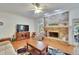 Comfortable living room with a brick fireplace, hardwood floors, and neutral furniture at 603 S Sylvan Dr, Brandon, FL 33510