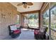 Inviting sunroom featuring brick detail, comfortable seating, and views of the landscaped backyard at 603 S Sylvan Dr, Brandon, FL 33510