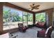 Cozy sunroom with ceiling fan, brick accents, and access to the beautifully landscaped backyard at 603 S Sylvan Dr, Brandon, FL 33510