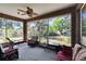 Relaxing sunroom with brick accents, ceiling fan, and serene backyard views at 603 S Sylvan Dr, Brandon, FL 33510