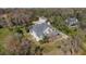A beautiful home with mature landscaping and neutral tones sits among lush Florida foliage at 6615 Ridge Top Dr, Trinity, FL 34655
