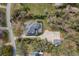 Aerial view of the home, pool, detached garage, and surrounding community at 6615 Ridge Top Dr, Trinity, FL 34655