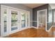 This bedroom features beautiful hardwood floors and sliding door access to the outdoor deck at 6615 Ridge Top Dr, Trinity, FL 34655