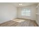 Cozy bonus room featuring wood floors and a large window at 6615 Ridge Top Dr, Trinity, FL 34655