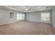 An expansive bonus room with natural light, tray ceilings and neutral carpet at 6615 Ridge Top Dr, Trinity, FL 34655