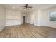 Open bonus room with wood floors and an abundance of natural light from a bright window at 6615 Ridge Top Dr, Trinity, FL 34655