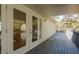 Attached deck showing access into the home through double doors, perfect for indoor-outdoor entertaining at 6615 Ridge Top Dr, Trinity, FL 34655