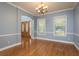 Traditional dining room with hardwood floors, chandelier, and arched doorway at 6615 Ridge Top Dr, Trinity, FL 34655