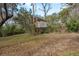 Exterior shot of the shed sitting on a large yard that's surrounded by mature trees at 6615 Ridge Top Dr, Trinity, FL 34655