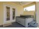 An inviting hot tub located on a covered lanai with a ceiling fan and French doors at 6615 Ridge Top Dr, Trinity, FL 34655