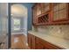 Butler's pantry features custom wood cabinets, wine rack and countertop space at 6615 Ridge Top Dr, Trinity, FL 34655