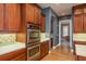 Chef's kitchen with stainless steel double ovens and beautiful wood cabinetry at 6615 Ridge Top Dr, Trinity, FL 34655