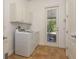Functional laundry room with white cabinetry and easy access to the patio at 6615 Ridge Top Dr, Trinity, FL 34655