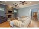 Inviting living room features a stone fireplace, hardwood floors, and neutral paint scheme at 6615 Ridge Top Dr, Trinity, FL 34655
