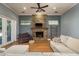 Cozy living room with stone fireplace, comfortable seating, and ample natural light at 6615 Ridge Top Dr, Trinity, FL 34655