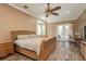 This main bedroom has hardwood floors, a ceiling fan, and access to the pool deck at 6615 Ridge Top Dr, Trinity, FL 34655