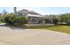 Rear exterior view of a yellow two-story home with a screen enclosed pool at 6615 Ridge Top Dr, Trinity, FL 34655