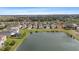 Aerial view of the neighborhood featuring a community pond and lush greenery at 7086 Chatum Light Run, Bradenton, FL 34212