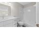 Clean, white bathroom with vanity, toilet, and shower-tub combo, offering a modern and functional space at 7086 Chatum Light Run, Bradenton, FL 34212
