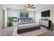 A comfortable bedroom with a large bed, ceiling fan, and natural light, creating a relaxing retreat at 7086 Chatum Light Run, Bradenton, FL 34212