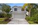 Charming two-story home with a well-manicured lawn and a two-car garage at 7086 Chatum Light Run, Bradenton, FL 34212