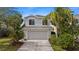Charming home with tropical landscaping and a well-maintained lawn at 7086 Chatum Light Run, Bradenton, FL 34212