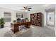 Inviting home office with a wooden desk, bookshelf, and comfortable seating for productive work at 7086 Chatum Light Run, Bradenton, FL 34212