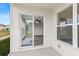 A screened lanai offering a view of the interior through sliding glass doors at 7086 Chatum Light Run, Bradenton, FL 34212