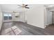 Bright living room with lots of windows, ceiling fans, and gray wood-look flooring at 7086 Chatum Light Run, Bradenton, FL 34212