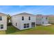 Two-story home with large windows and a well-manicured backyard at 7086 Chatum Light Run, Bradenton, FL 34212