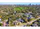 An aerial view shows the property, including its neat landscaping and proximity to the surrounding greenery and the bay at 906 S Sterling Ave, Tampa, FL 33629