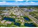 An aerial view shows the surrounding community buildings by the lake and busy highways at 10263 Gandy N Blvd # 105, St Petersburg, FL 33702