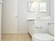 Modest bathroom with a single sink vanity, toilet, and tile flooring at 10263 Gandy N Blvd # 105, St Petersburg, FL 33702