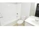 Bright, neutral bathroom with tub, toilet, and white vanity with chrome faucet at 10263 Gandy N Blvd # 105, St Petersburg, FL 33702