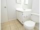Simple bathroom design featuring a white vanity, toilet, and neutral tile flooring at 10263 Gandy N Blvd # 105, St Petersburg, FL 33702