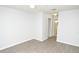Bright bedroom with neutral walls and light wood-look flooring; a bathroom doorway is visible at 10263 Gandy N Blvd # 105, St Petersburg, FL 33702