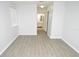 Bright bedroom with neutral walls and light wood-look flooring; a bathroom doorway is visible at 10263 Gandy N Blvd # 105, St Petersburg, FL 33702