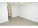 View of the spacious bedroom with wood floors and entry to bathroom at 10263 Gandy N Blvd # 105, St Petersburg, FL 33702