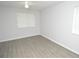 Bright bedroom with light gray walls, ceiling fan, and light wood-look flooring at 10263 Gandy N Blvd # 105, St Petersburg, FL 33702
