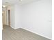 Bright bedroom featuring light grey wood floors, white walls, and doorway at 10263 Gandy N Blvd # 105, St Petersburg, FL 33702